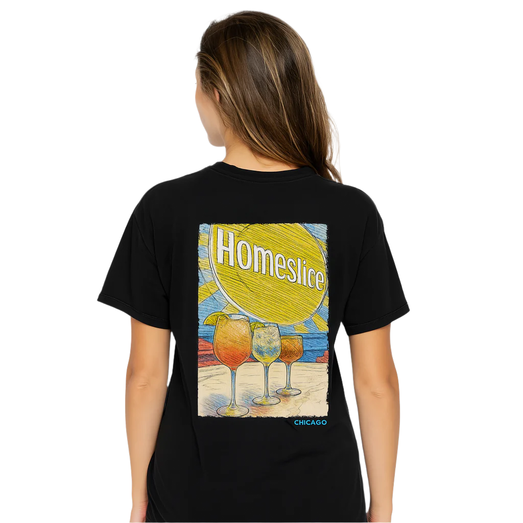 Person wearing a black t-shirt with a colorful graphic design on the back, featuring the word 'Homeslice' and images of drinks.