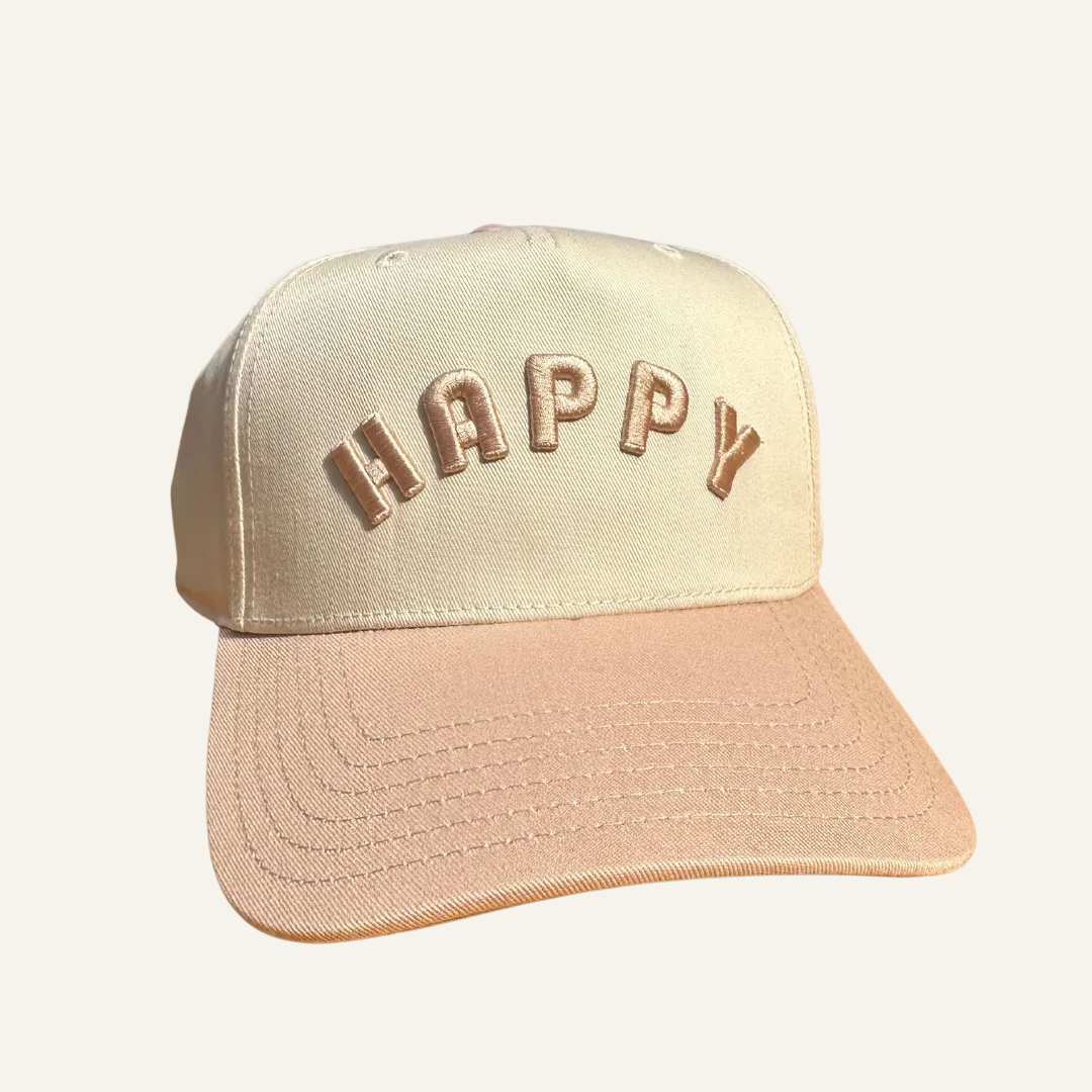 Beige cap with 'HAPPY' text on a white background