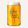 Glass of beer with 'Welcome to Paradise Park' flamingo design on a white background