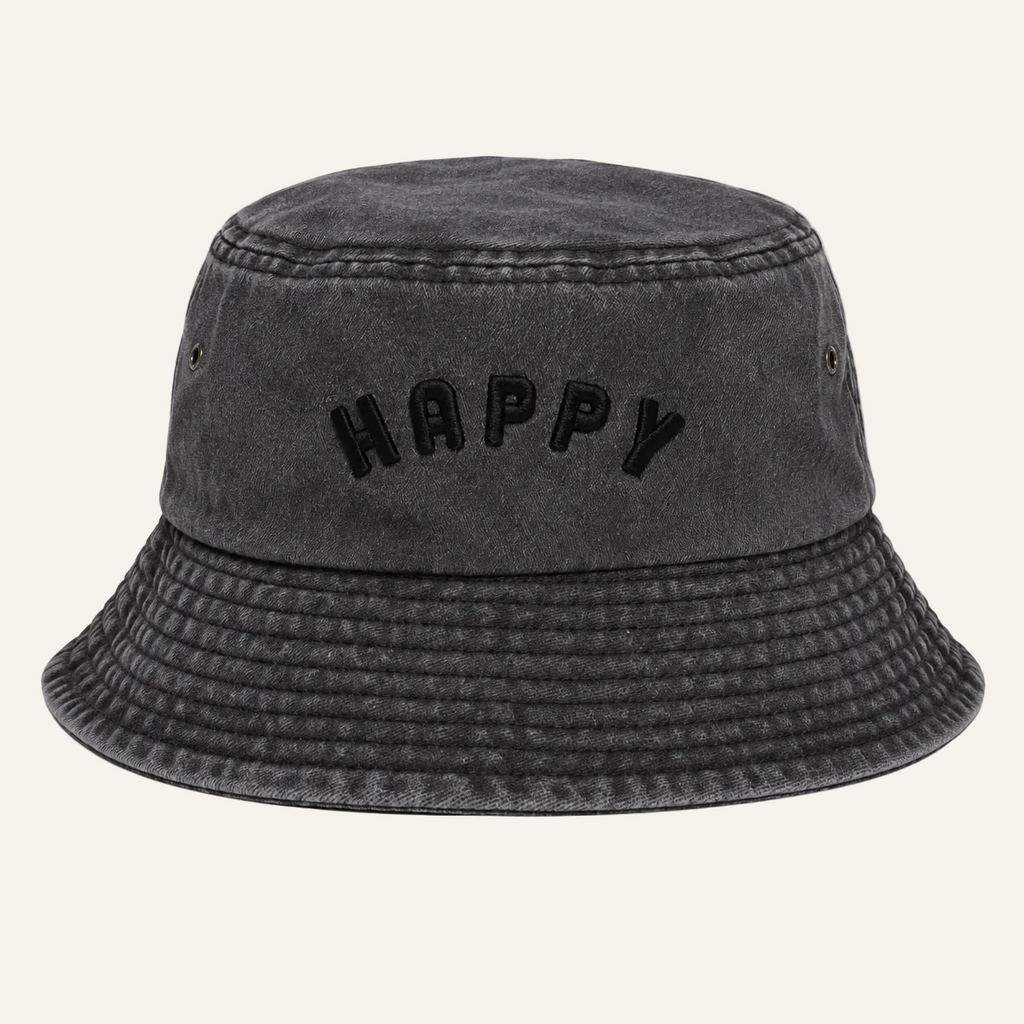 A dark gray washed cotton bucket hat with the word 'HAPPY' embroidered in black across the front, shown against a plain white background.