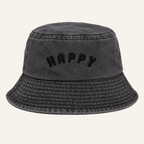 A dark gray washed cotton bucket hat with the word 'HAPPY' embroidered in black across the front, shown against a plain white background.