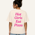 A woman shown from the back wearing a cream-colored oversized t-shirt with the phrase 'Hot Girls Eat Pizza' printed in bright pink text on the back.