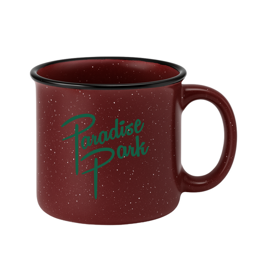 Red speckled mug with 'Paradise Park' text on a white background