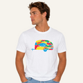 A man wearing a white crew-neck t-shirt with a colorful retro camper graphic on the chest, paired with light blue jeans, set against a plain white background.