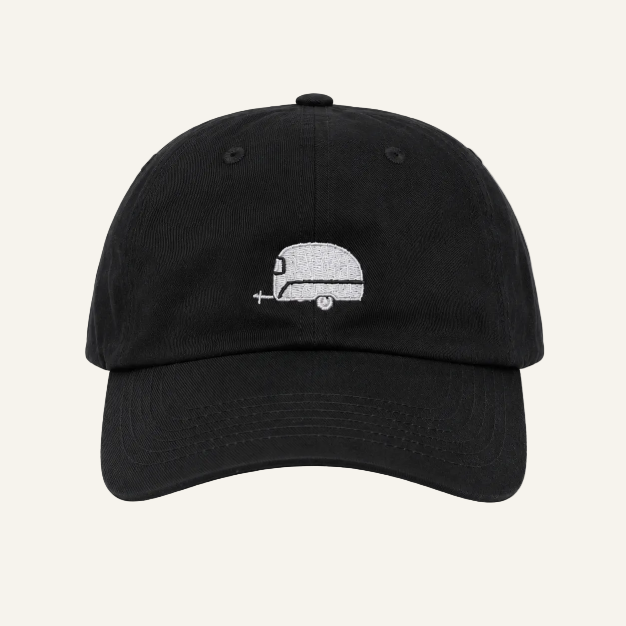 A black dad hat baseball cap featuring a small white embroidered retro camper graphic on the front, set against a plain white background.