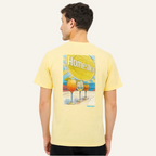 Man wearing a yellow t-shirt with 'Homeslice' graphic on the back