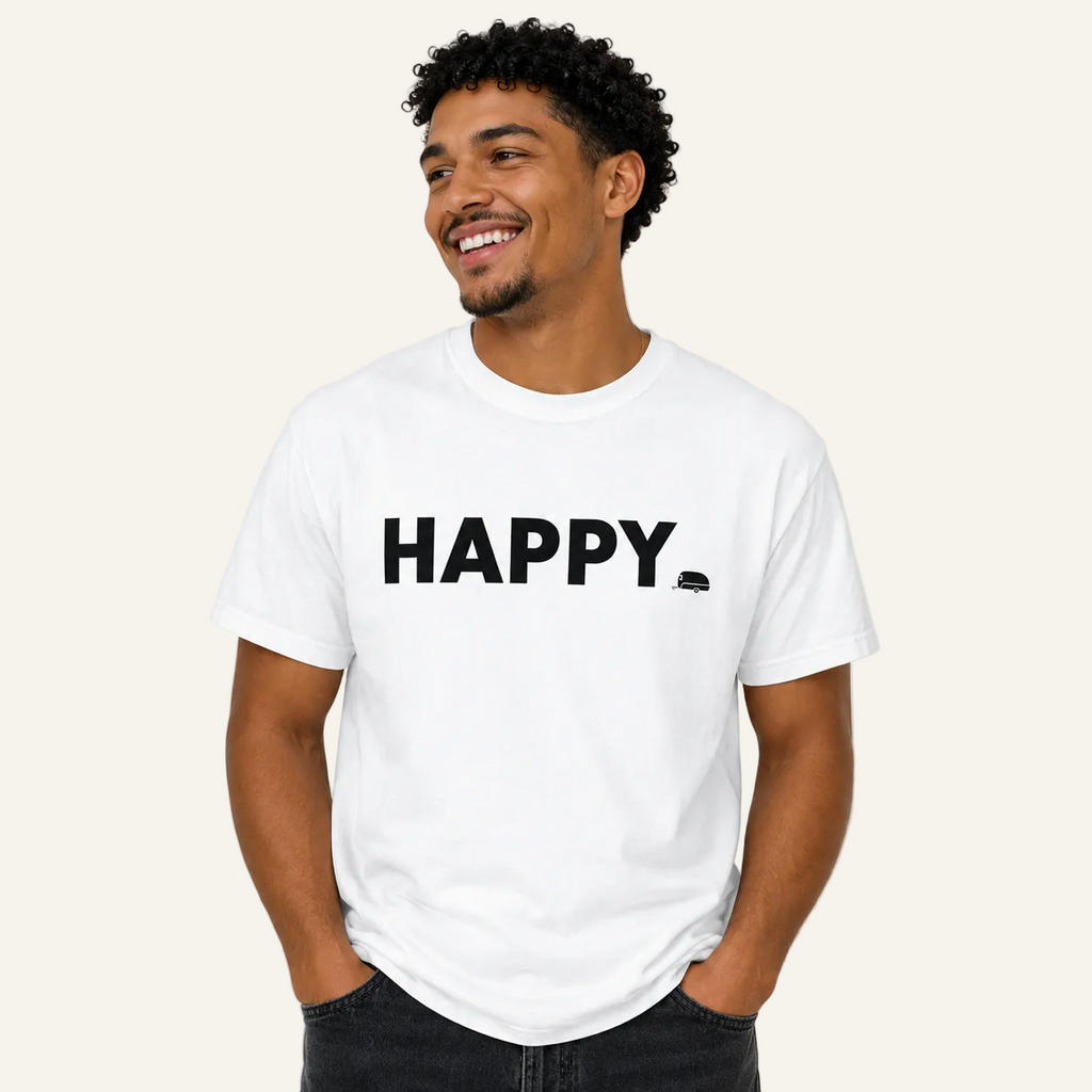 A man wearing a white crewneck t-shirt with the word 'HAPPY' printed in bold black letters across the chest, paired with dark jeans, set against a plain light gray background.